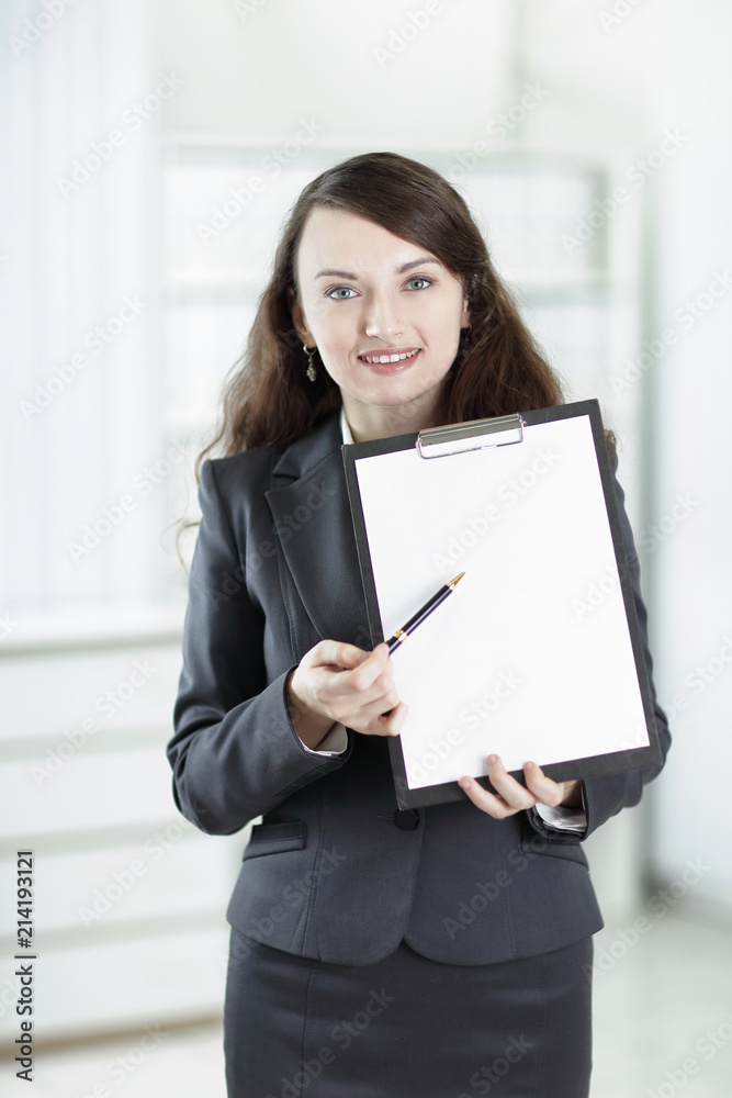 modern business woman pointing at blank sheet. modern business woman pointing at blank sheet.