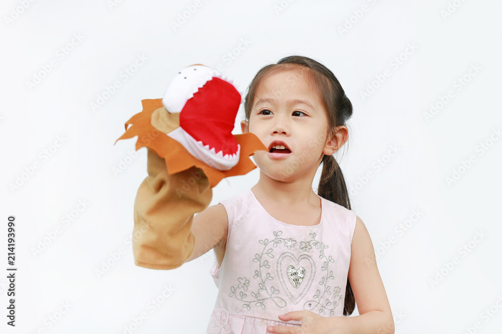 Adorable little Asian child girl hand wear and playing Lion puppets on white background. Educations concept. Adorable little Asian child girl hand wear and playing Lion puppets on white background. Educations concept.