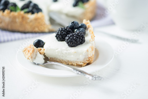 Piece of cheesecake with blueberries and blackberries