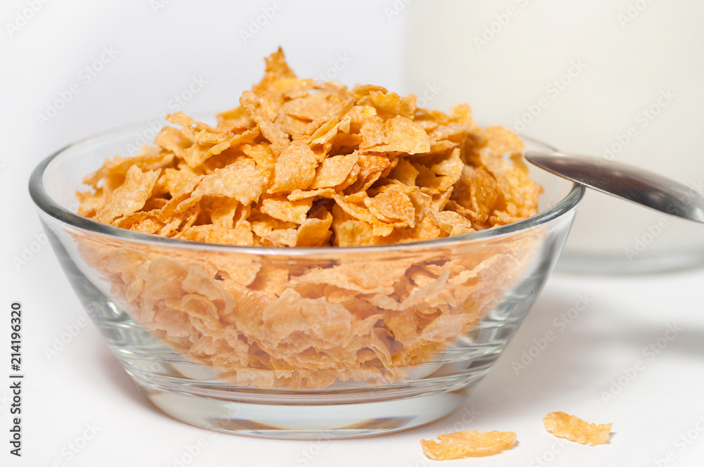 corn flakes in a glass bowl on a white background corn flakes in a glass bowl on a white background