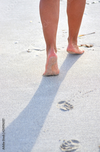 footprints on the wet sand on the beach