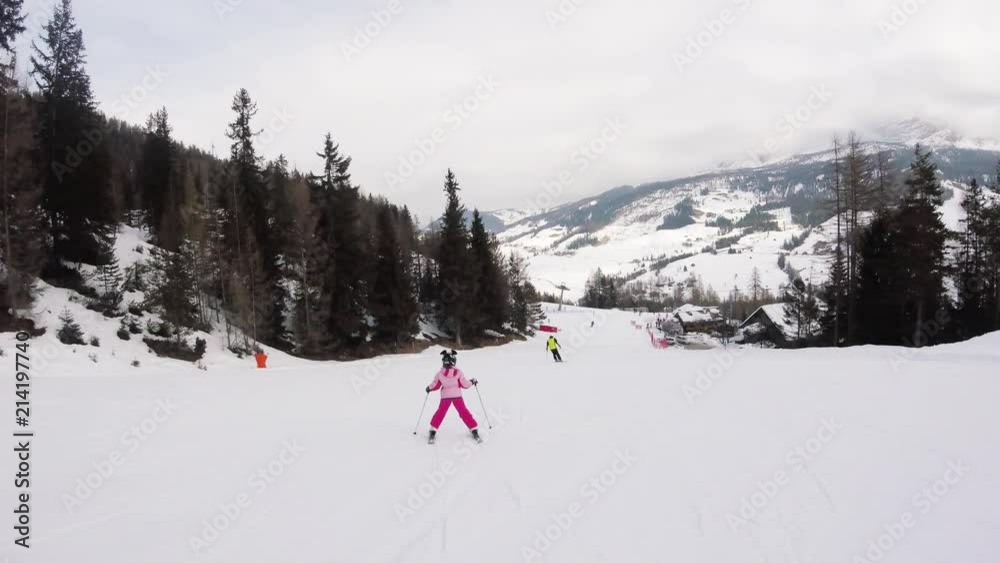 A little girl skiing in mountains, action camera footage A little girl skiing in mountains, action camera footage