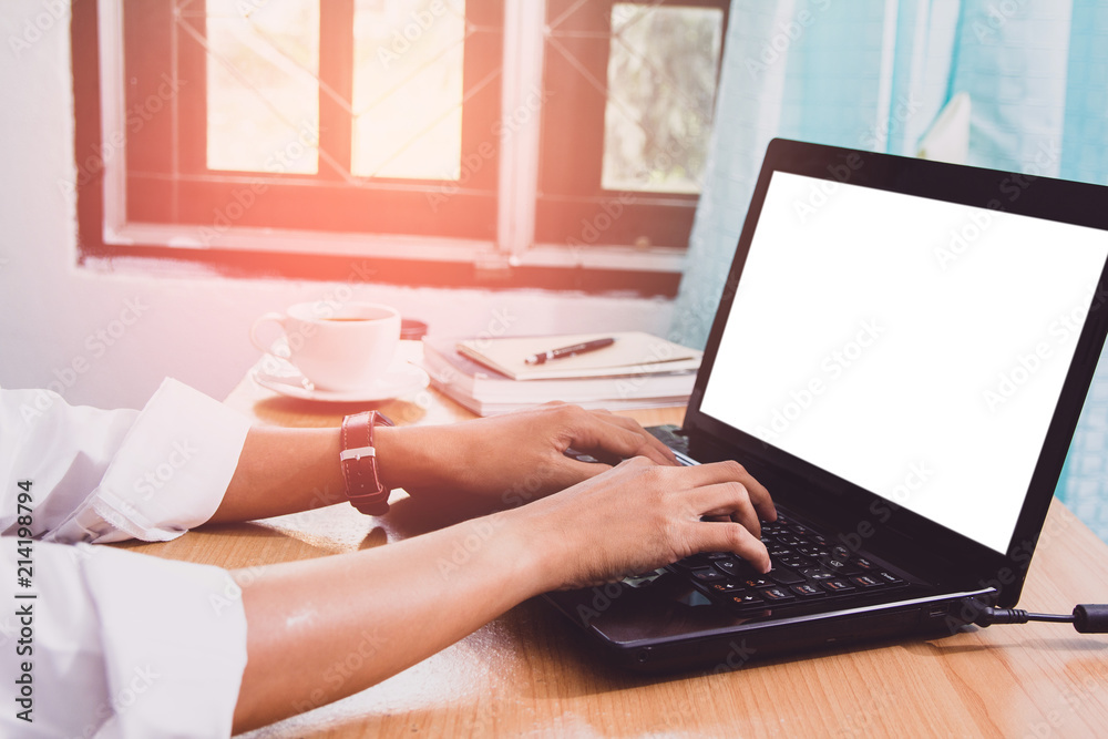 Naklejka premium Business man sitting using laptop with blank screen on desk in office at home