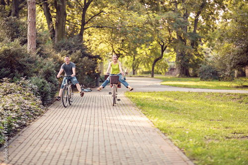 Wallpaper Mural Smiling father and mother with kid on bicycles having fun in park. Family sport and healthy lifestyle. Torontodigital.ca