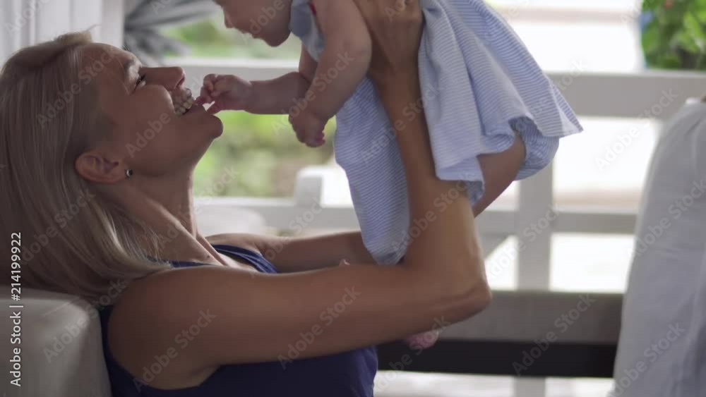 Young mother kiss her baby daughter Young mother kiss her baby daughter