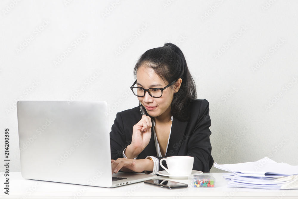 Happy business Asian woman working with laptop at white working table, diligent professional working woman. Happy business Asian woman working with laptop at white working table, diligent professional working woman.