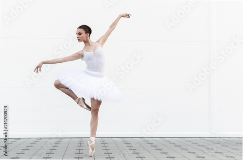 Fototapeta Naklejka Na Ścianę i Meble -  Ballerina in attitude pose outside