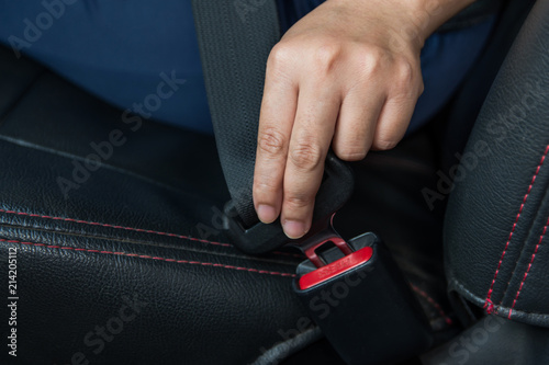Car seat belt. woman fastens the seat belt on car Safe driving. Safety belt in hand.