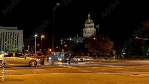 Timelapse of the Denver Capitol at Night on a Corner with Cars and People Moving 4k photo