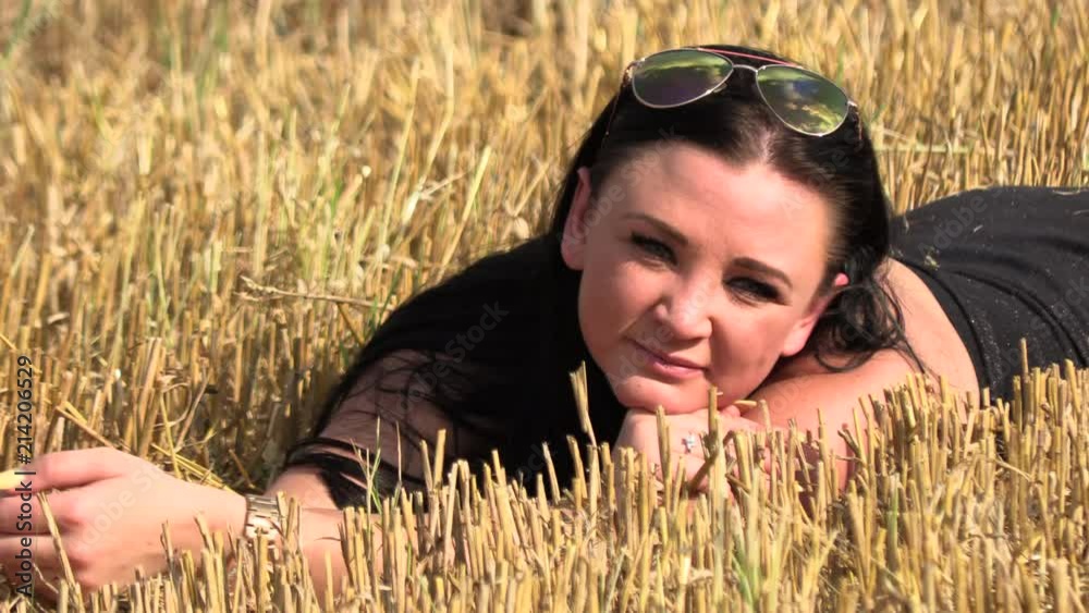 The brunette lies in a crooked field,Slow motion The brunette lies in a crooked field,Slow motion