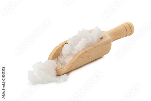 Organic sea white salt tablets in a wooden bowl on white background