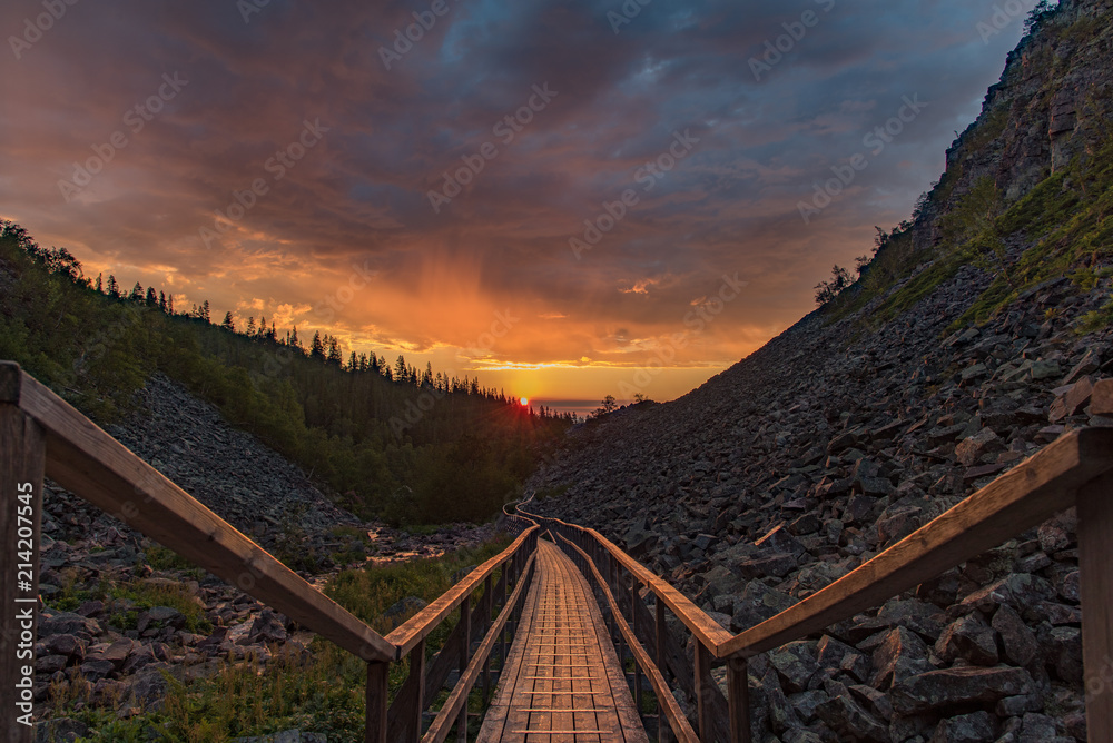 sunrise over a footbridge in fulufjallet national park Sweden