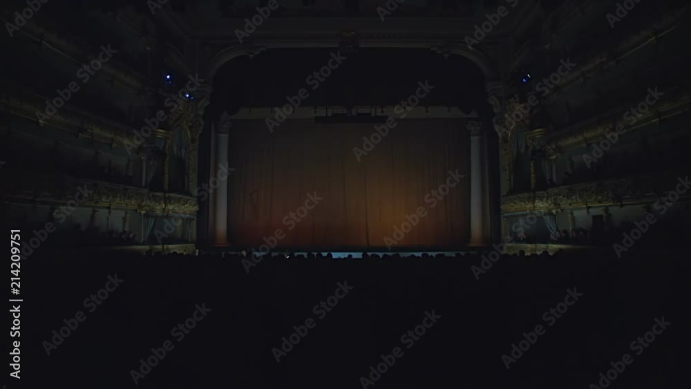 On the stage of the theater, the light goes out, the curtain opens against a green background, green screen, chroma key