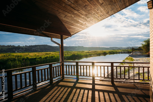 view of beautiful sunset over river from wooden terrace © LIGHTFIELD STUDIOS