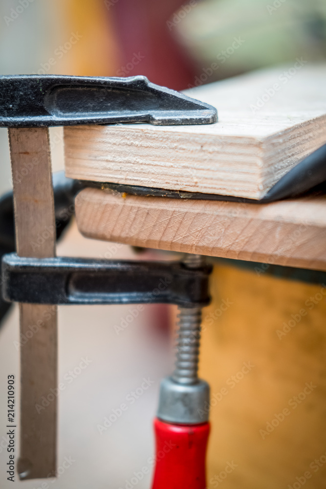 Obraz premium repair of the bicycle camera at home, the clamp clamps two glued wooden bars