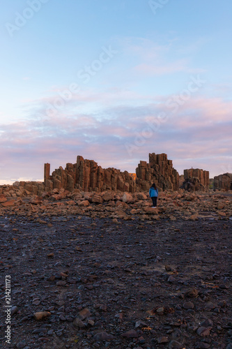 One person standing in front of rock formation at Bombo Quarry.