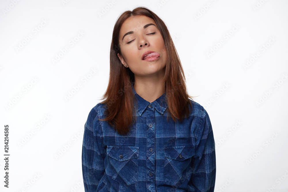 Stressful woman closing her eyes while crying having tongue out, feeling tension,looking upset having grief. Exhausted woman regrets what she done. Sorrowed female isolated over white studio wall. Stressful woman closing her eyes while crying having tongue out, feeling tension,looking upset having grief. Exhausted woman regrets what she done. Sorrowed female isolated over white studio wall.