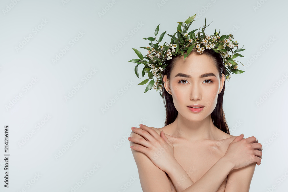 beautiful nude asian girl in floral wreath, isolated on grey beautiful nude asian girl in floral wreath, isolated on grey