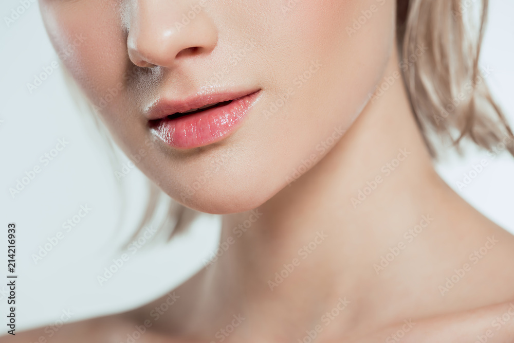 cropped view of female face, isolated on grey cropped view of female face, isolated on grey