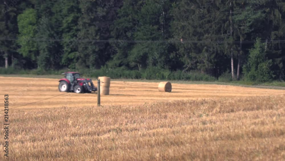 The tractor collects the Chopped hay with round bales,Slow motion The tractor collects the Chopped hay with round bales,Slow motion