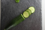 chop the cucumber on a stone background