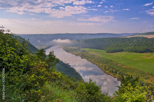 Beautiful summer landscape with morning fog over the river. Dniester Canyon, Ukraine, Europe