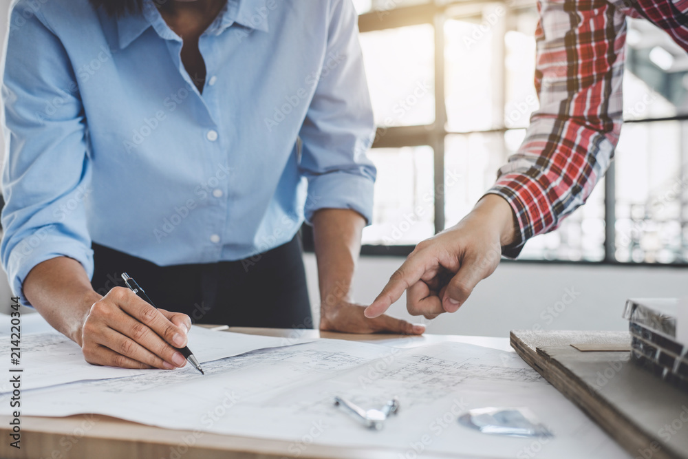 Hands of architect or engineer working on blueprint meeting for project working with partner on model building and engineering tools in working site, Construction concept