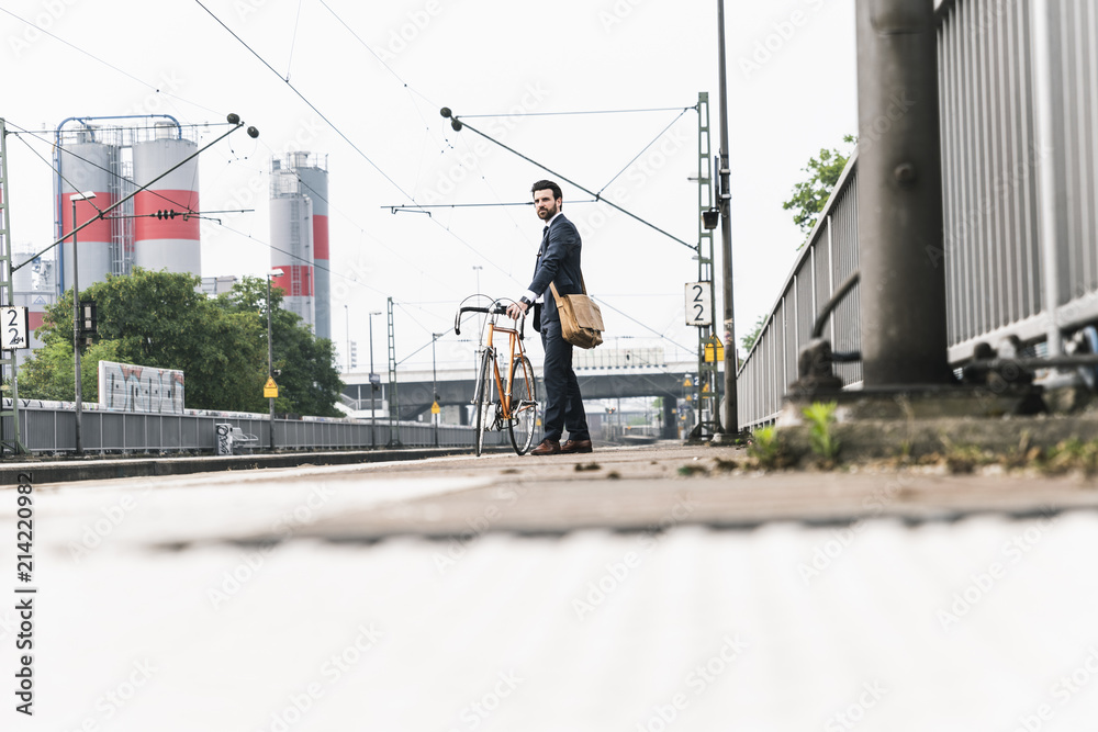 Businessman with bicycle waiting at the platform Businessman with bicycle waiting at the platform