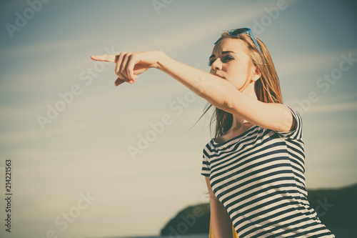 woman casual style pointing on sky background