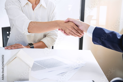 Handshake after good cooperation, Real estate broker residential agent shaking hands with customer after good deal agreement house rent listing contract