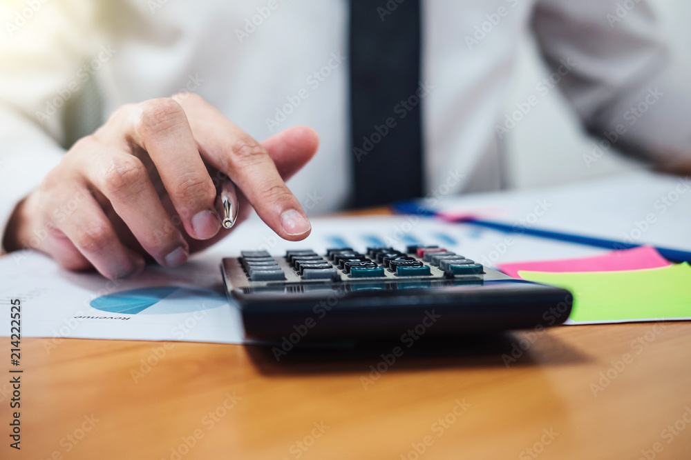 Business man or accountant working Financial investment on calculator with calculate Analyze business and market growth on financial document data graph Business man or accountant working Financial investment on calculator with calculate Analyze business and market growth on financial document data graph