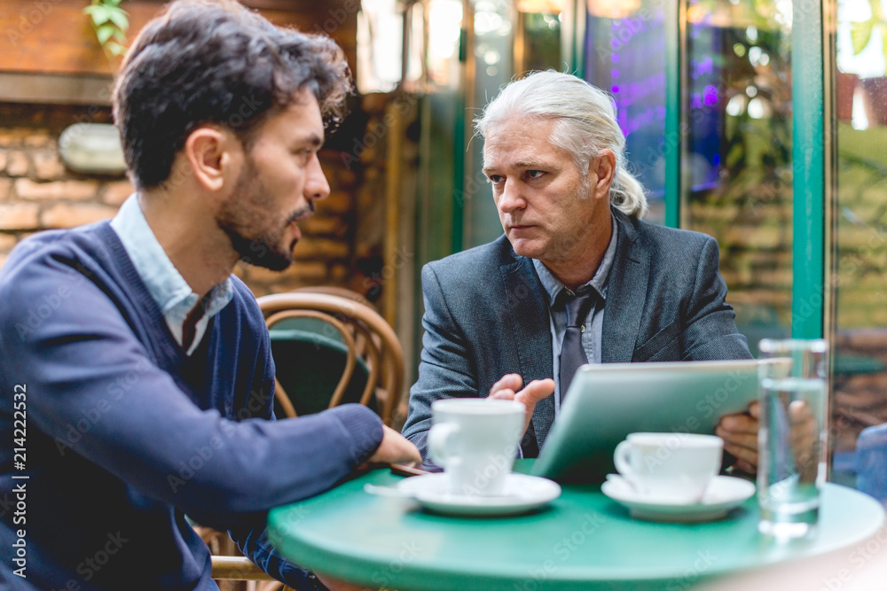 Two colleagues have a meeting in the cafe Two colleagues have a meeting in the cafe