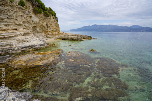 Fototapeta Naklejka Na Ścianę i Meble -  Desimi Beach Golf and nearby Island with clear water in Greece