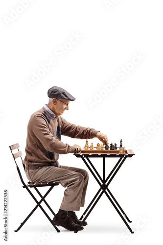 Senior sitting at a table and playing a game of chess © Ljupco Smokovski