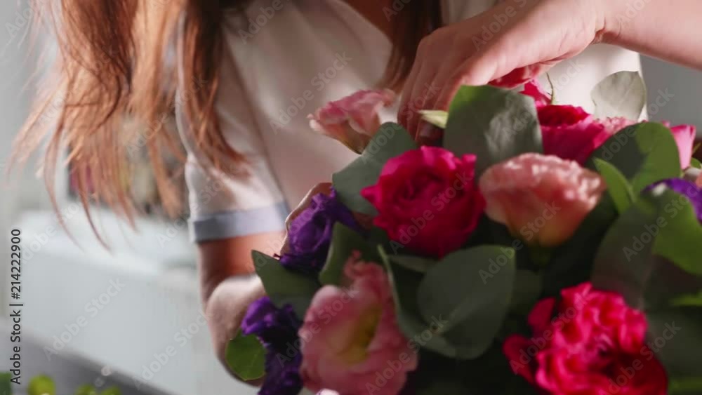 Florist girl makes a floral box in a flower salon, close-up Florist girl makes a floral box in a flower salon, close-up