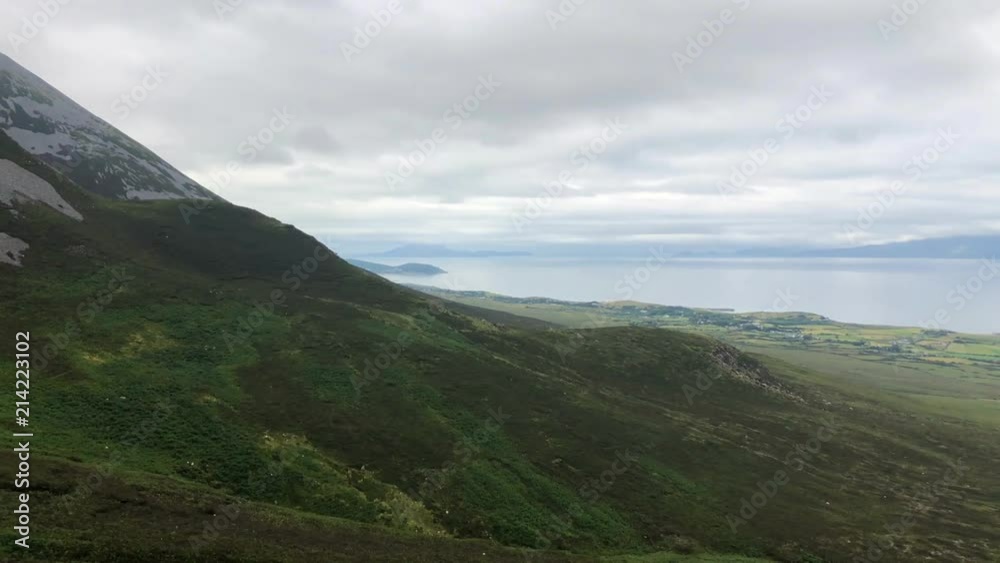 View from Croagh Patrick mountain in Co. Mayo, Westport, West coast of Ireland, Atlantic ocean. Amazing scenic sea and mountain landscape with islands in cloudy day. View from Croagh Patrick mountain in Co. Mayo, Westport, West coast of Ireland, Atlantic ocean. Amazing scenic sea and mountain landscape with islands in cloudy day.