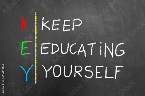 Key keep education yourself text on blackboard.