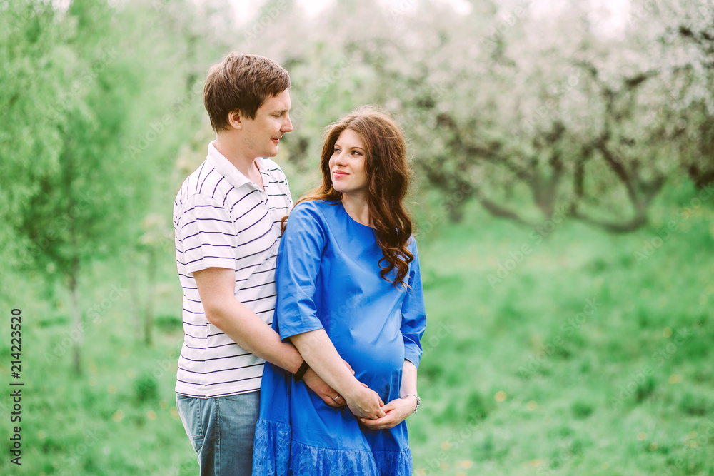 Close up portrait of lovely future parents during sunset on nature apple tree background Close up portrait of lovely future parents during sunset on nature apple tree background