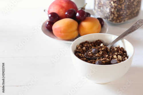 Bowl of chocolate granola on a white table
