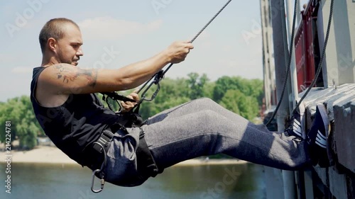 Guy is testing insurance on the bridge