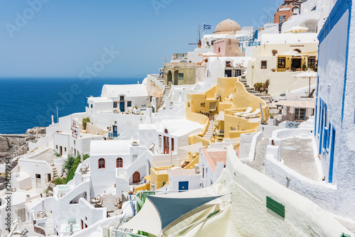 Tiny little white houses, hotels and small churches in the Oia village at Santorini, Greece.