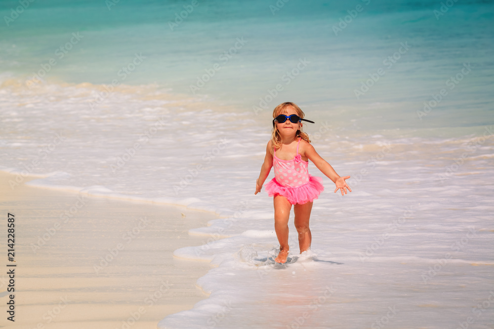 little girl run play with waves on beach little girl run play with waves on beach