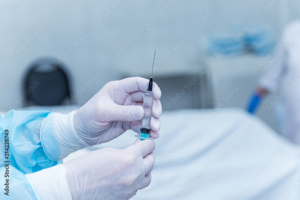 The hands of an anesthetist, who are taking medicine from the ampoule in a syringe. concept photo anesthesia, medicine without pain
