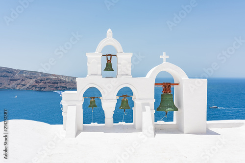 Green bells on roof of the church in the Oia village at Santorini, Greece.