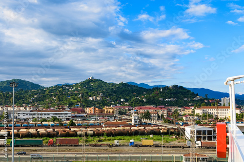 Port of Batumi, Georgian resort city and port at Black Sea – panoramic view of surrounding mountains from cargo ship in port in golden summer morning sunlight © Oleksii Fadieiev