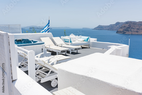 Cozy sunbeds with tiny swimming pool on top of the Oia village at Santorini, Greece. © zlatamarka