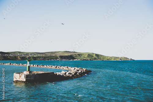 
Crimea sea lighthouse on the water and shore photo