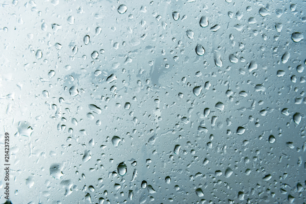 Textured background of window panes with a cloudy background. Natural pattern from a drop of rain on a cloudy background. Textured background of window panes with a cloudy background. Natural pattern from a drop of rain on a cloudy background.