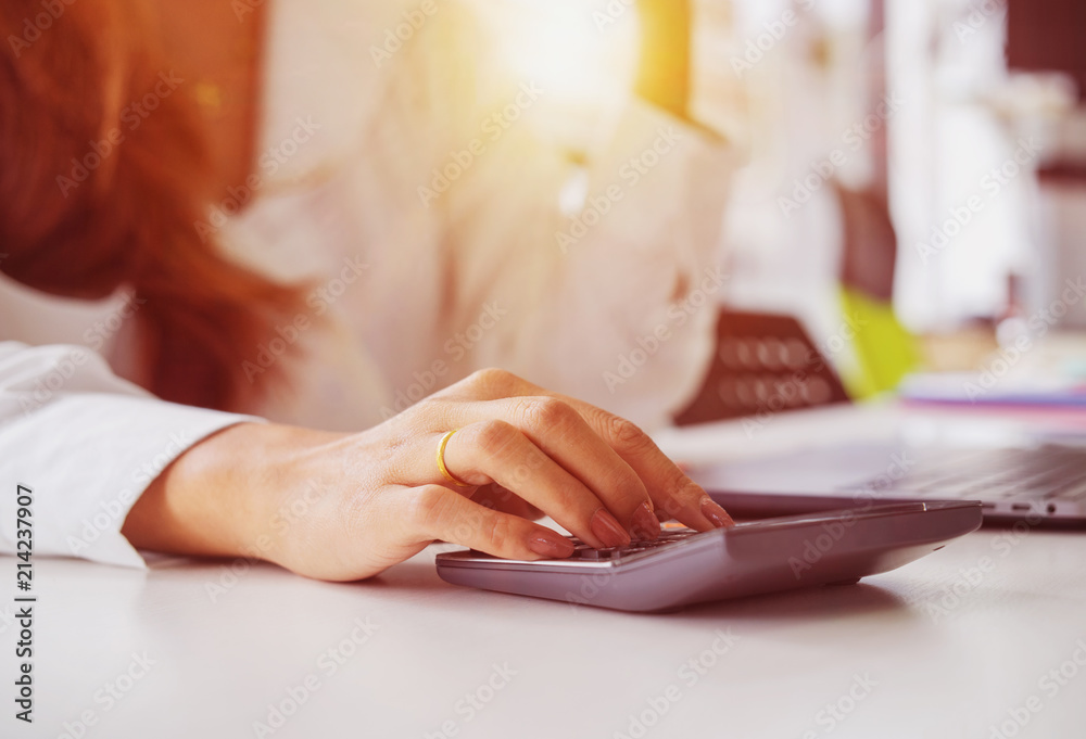Fototapeta premium Business woman calculating budget numbers, Invoices and financial adviser working.