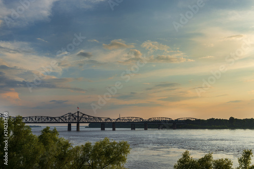 View of the Mississippi River with the Vicksburg Bridge on the background at sunset; Concept for travel in the USA and visit Mississippi